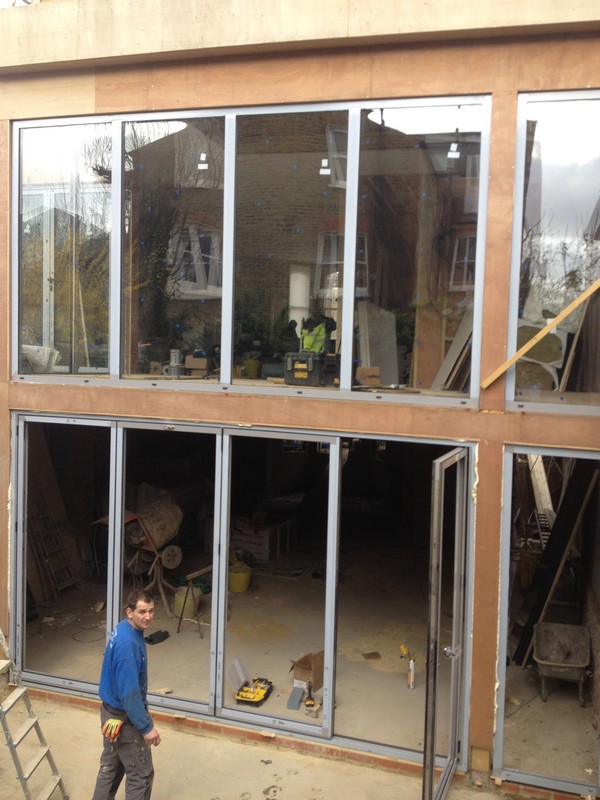 Aluminium bi-fold doors with two-storey glazing in Hampstead