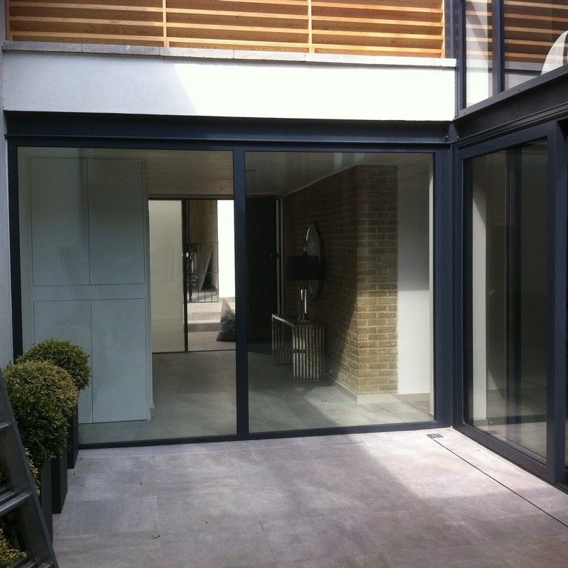 Floor-to-ceiling sliding doors opening to courtyard in Hampstead