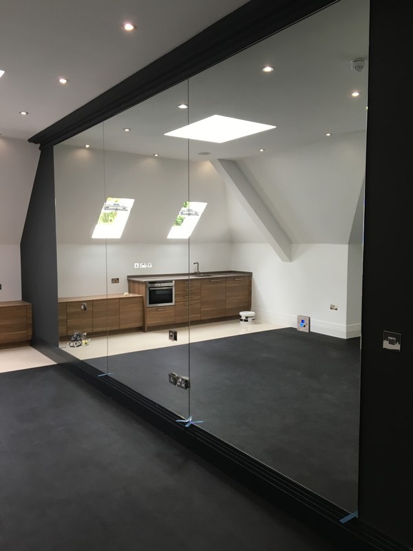 Frameless glass partition in loft conversion by Hampstead glaziers
